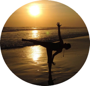 Katherine Sauer doing a yoga pose on a beach at sunset